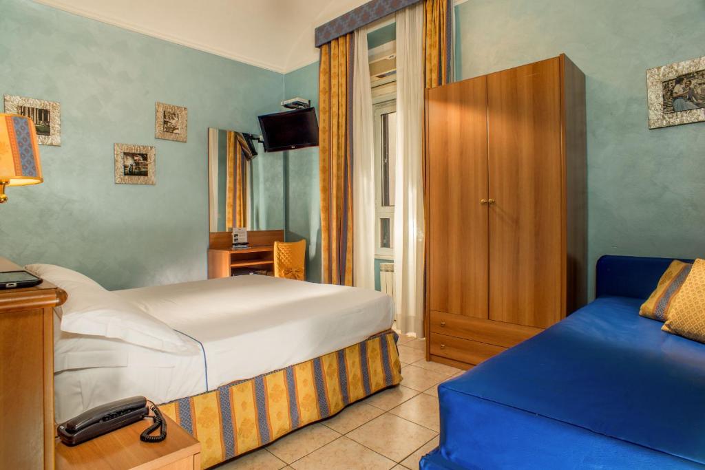 Postel nebo postele na pokoji v ubytování Hotel Assisi