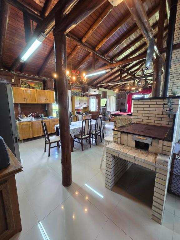a dining room with a table and some chairs at Cabana da lagoa in Osório