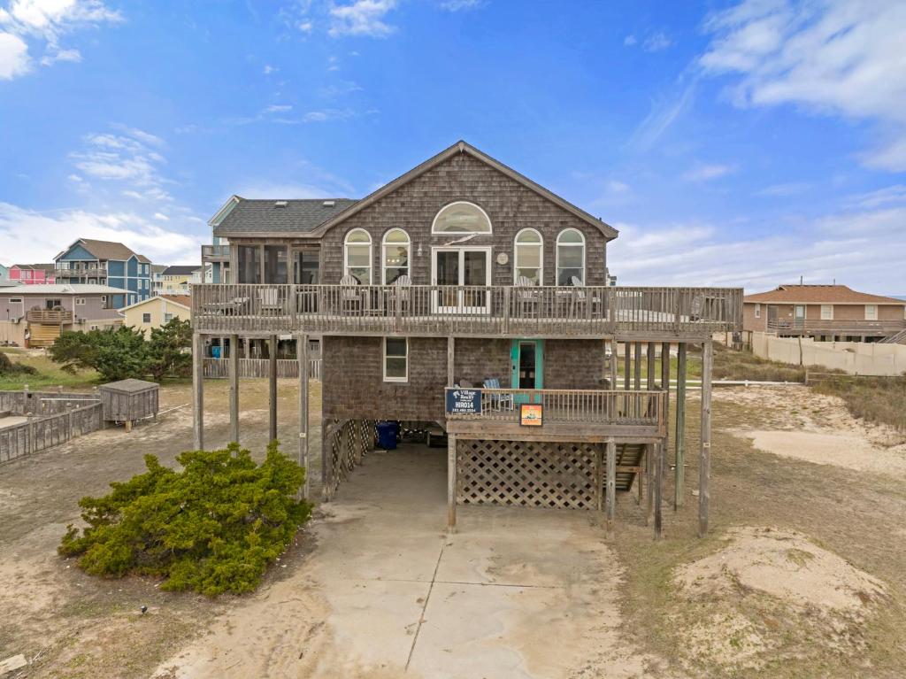 a house on the beach with a deck at The Pickled Mermaid in Rodanthe