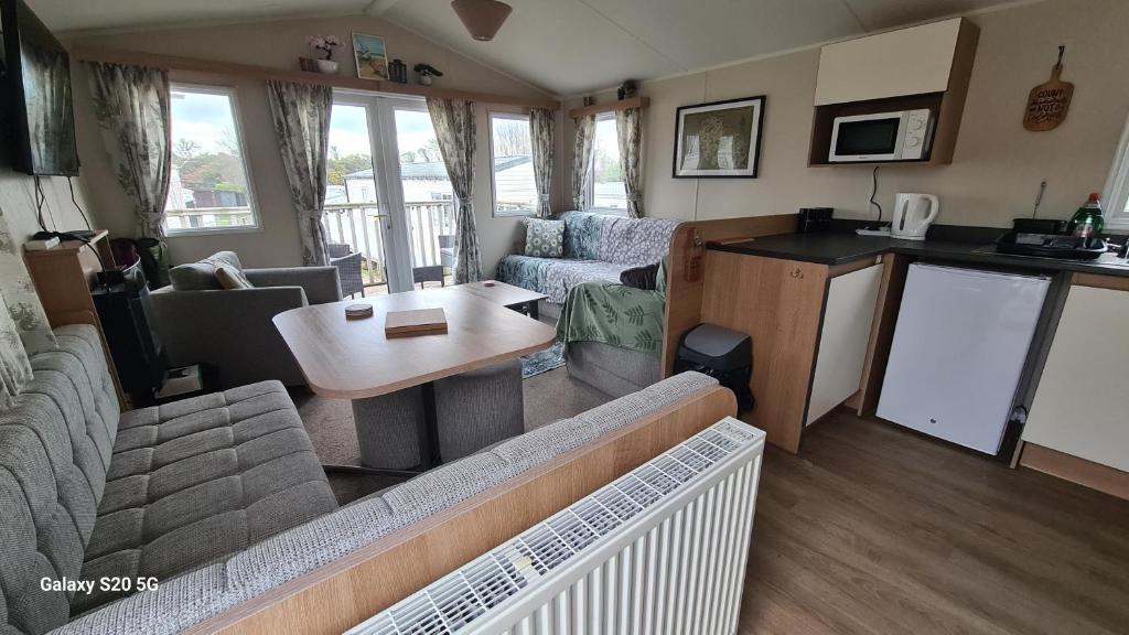 a living room with a couch and a table at Newydd nook in Anglesey