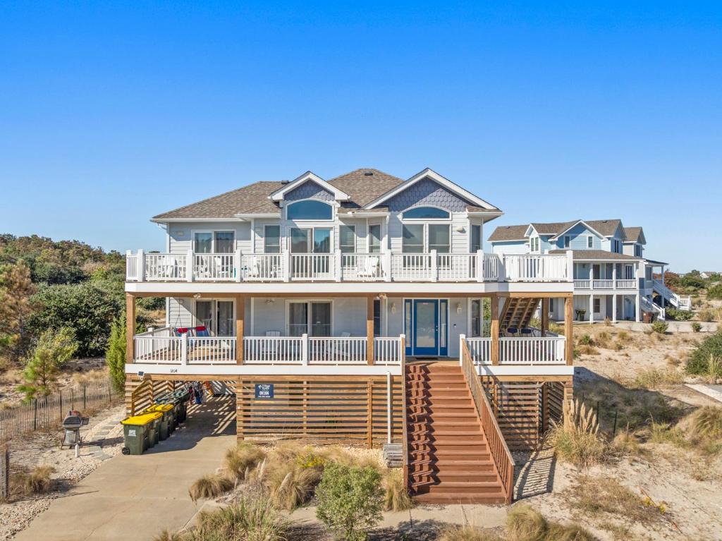 a large house with a deck on the beach at Anchors Away in Corolla