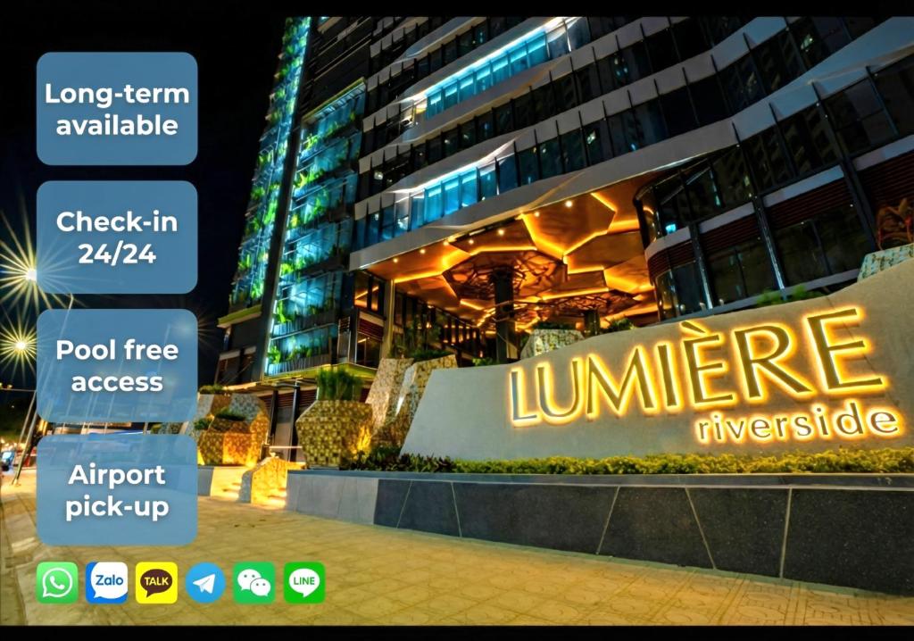a sign in front of a building at night at Clasio - Lumiere Riverside in Ho Chi Minh City