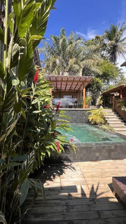 a house with a swimming pool in a yard at Tawa Caraíva in Caraíva