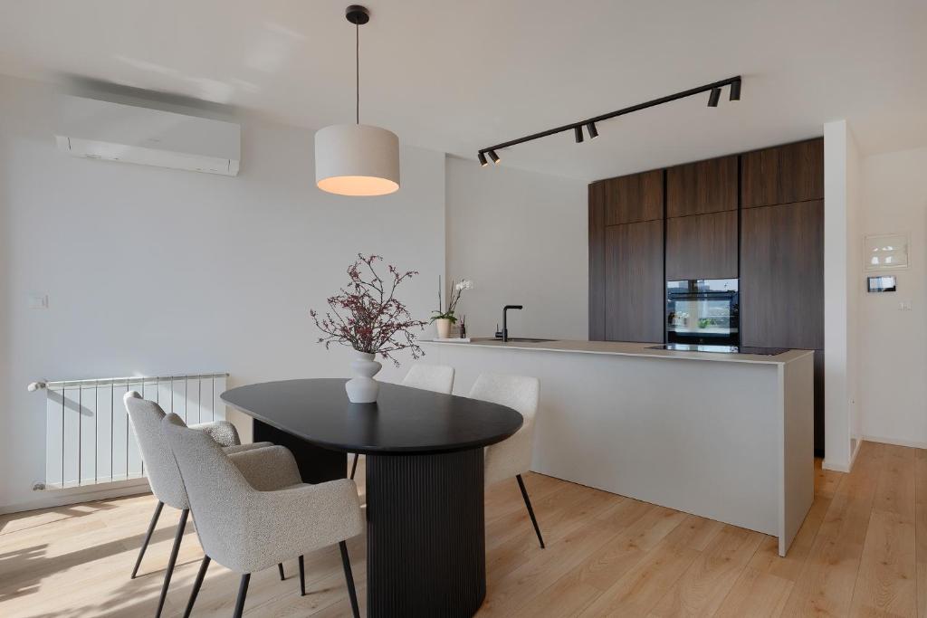 a kitchen and dining room with a table and chairs at Fiorea Apartment - Pula City Center With Private Garage Parking in Pula