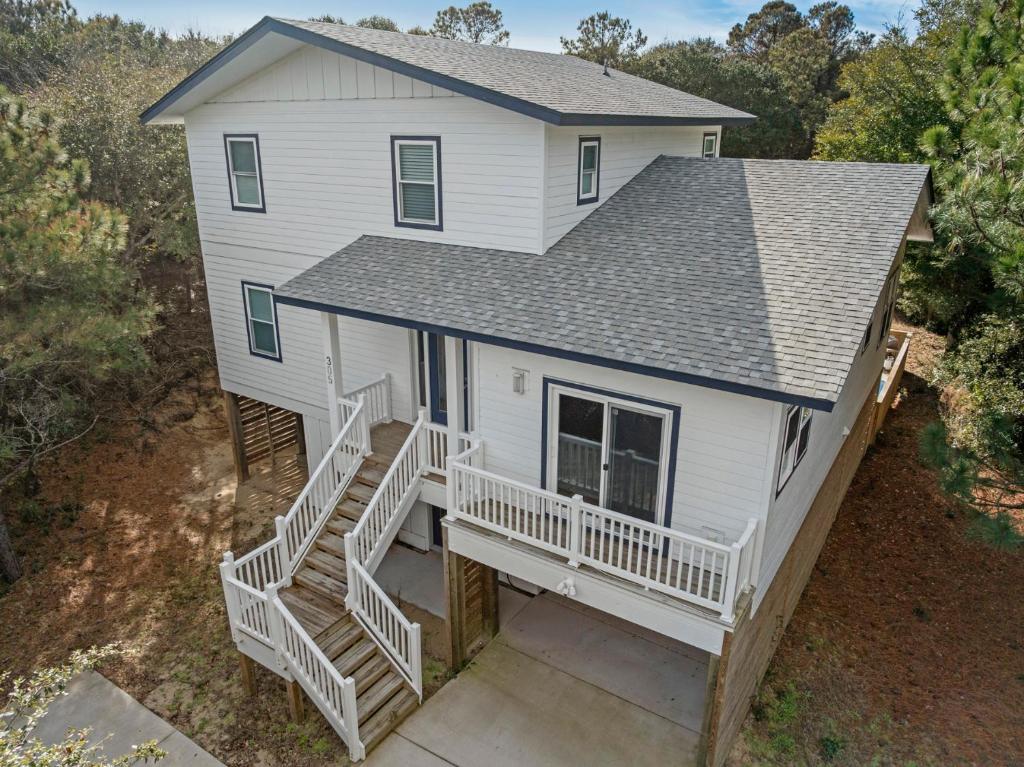 an aerial view of a white house with a porch at Wax Turtle in Southern Shores