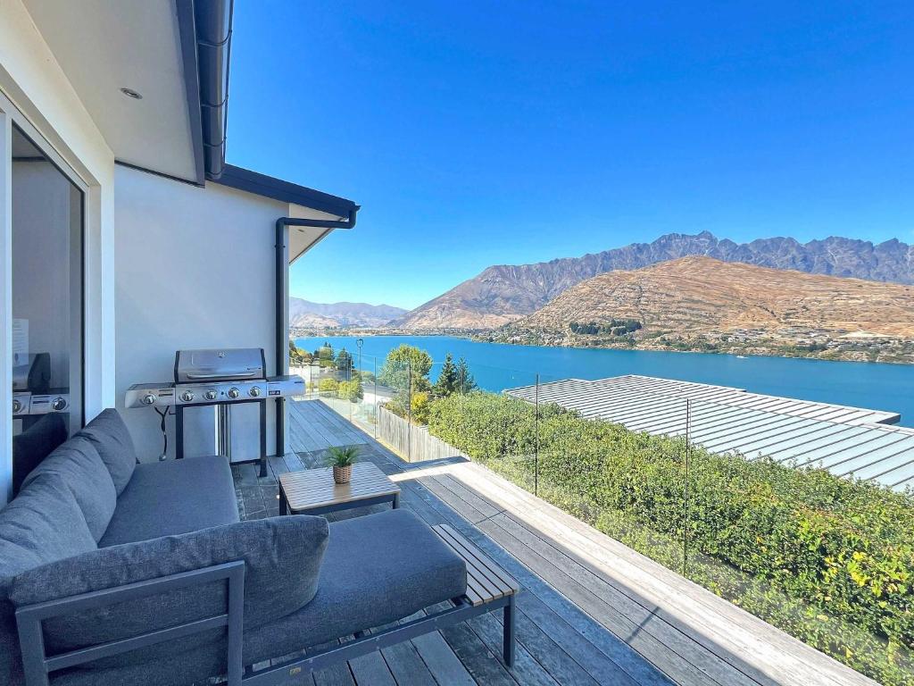 a living room with a view of the water at Epic Views and Deck | Spacious Queenstown Home in Queenstown