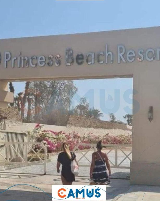 two women walking in front of a entrance to a beauty salon at CAMUS 354, Princess Resort in Hurghada