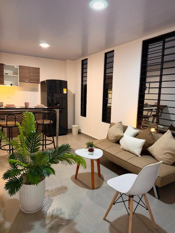 a living room with a couch and a table at Amazonía Luxury Loft 203 in Florencia
