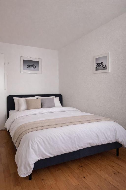 a bedroom with a large bed with two bikes on the wall at Central & cosy next to cathedral in Fribourg