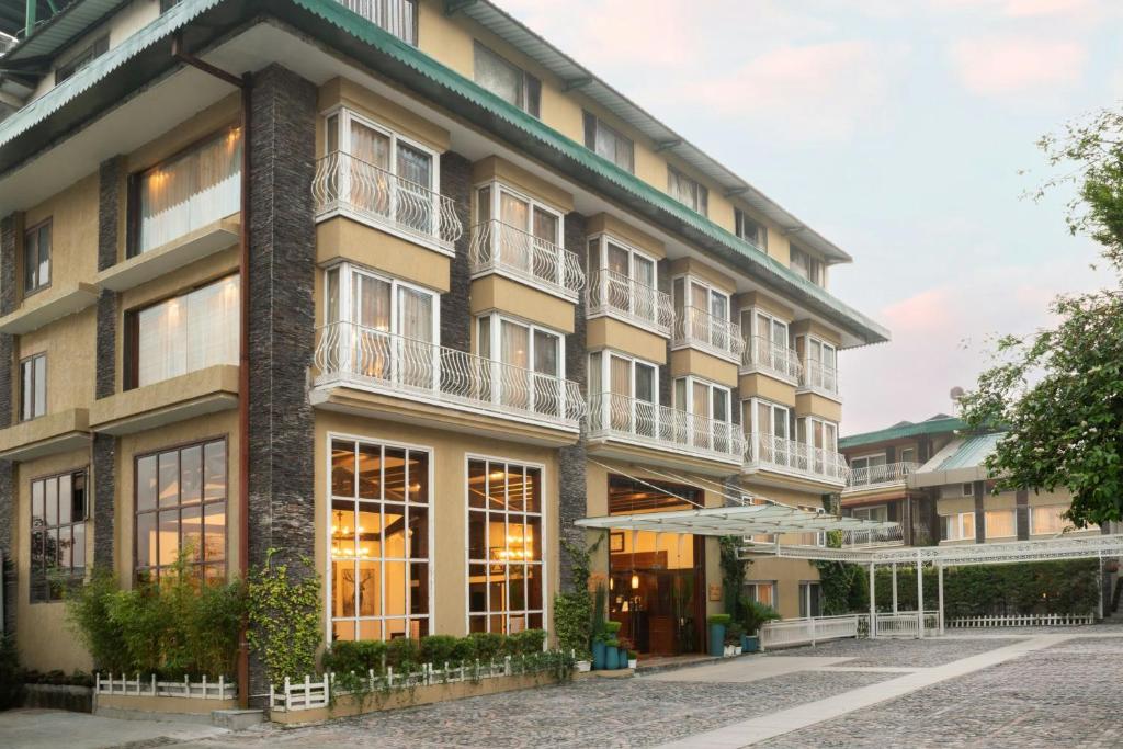 a large building with windows and balconies on it at The Fern Brentwood Resort, Mussoorie, Series by Marriott in Mussoorie