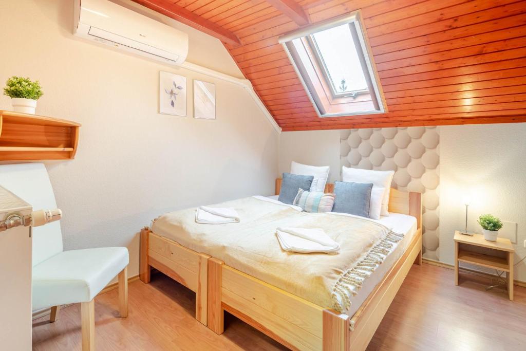 a bedroom with a large bed with a skylight at Calm and Relaxing Sleep in Soltvadkert