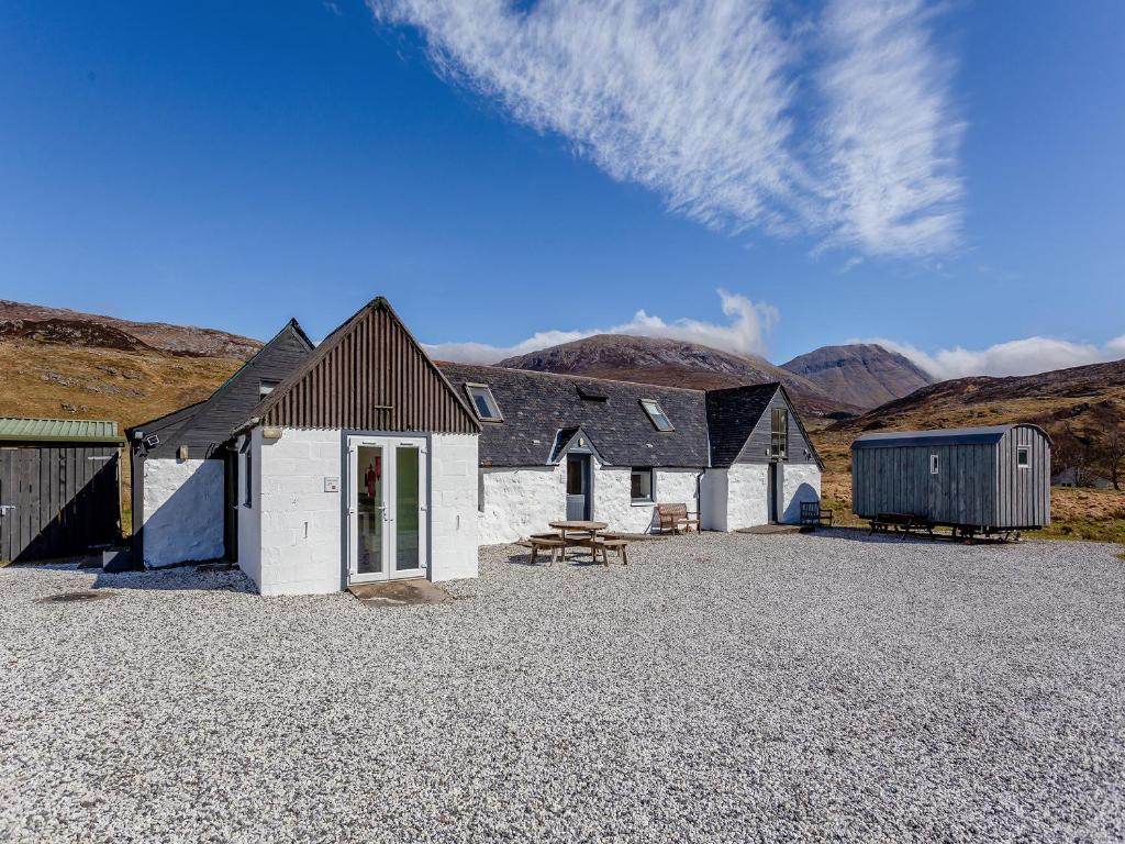 a group of buildings with mountains in the background at Quinag Studio Apartment - Uk49098 in Inchnadamph