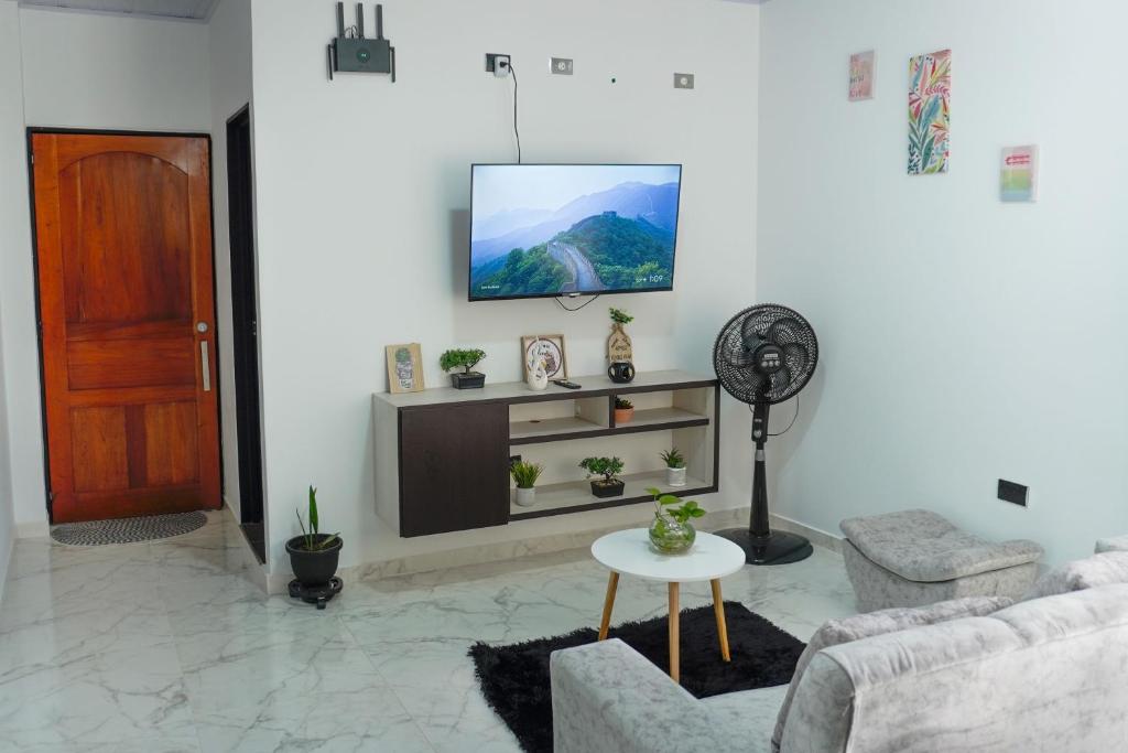 a living room with a tv on a white wall at Espacio Ideal 201 in Yopal