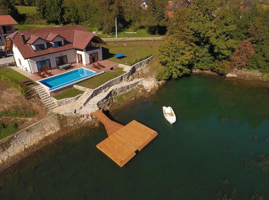 an aerial view of a house and a boat in the water at Jezerska Villa in Ogulin