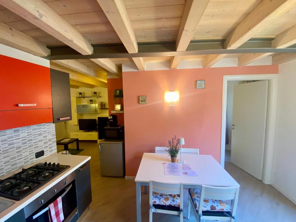 a kitchen with a stove and a white table at Casa Vacanze La Romantica in Chiavenna