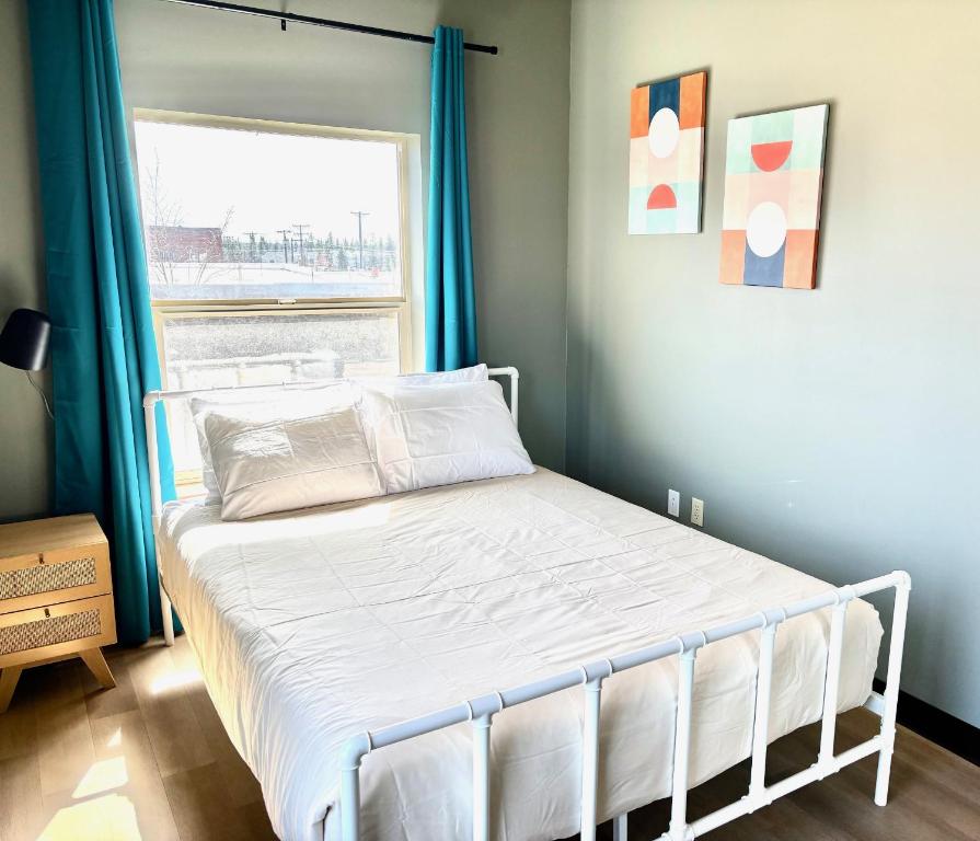 a bed in a bedroom with a window at Brewster Hall in Cheney