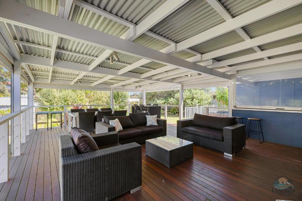 a large outdoor living room with couches and tables at Barefoot on O'Neil in Lancelin
