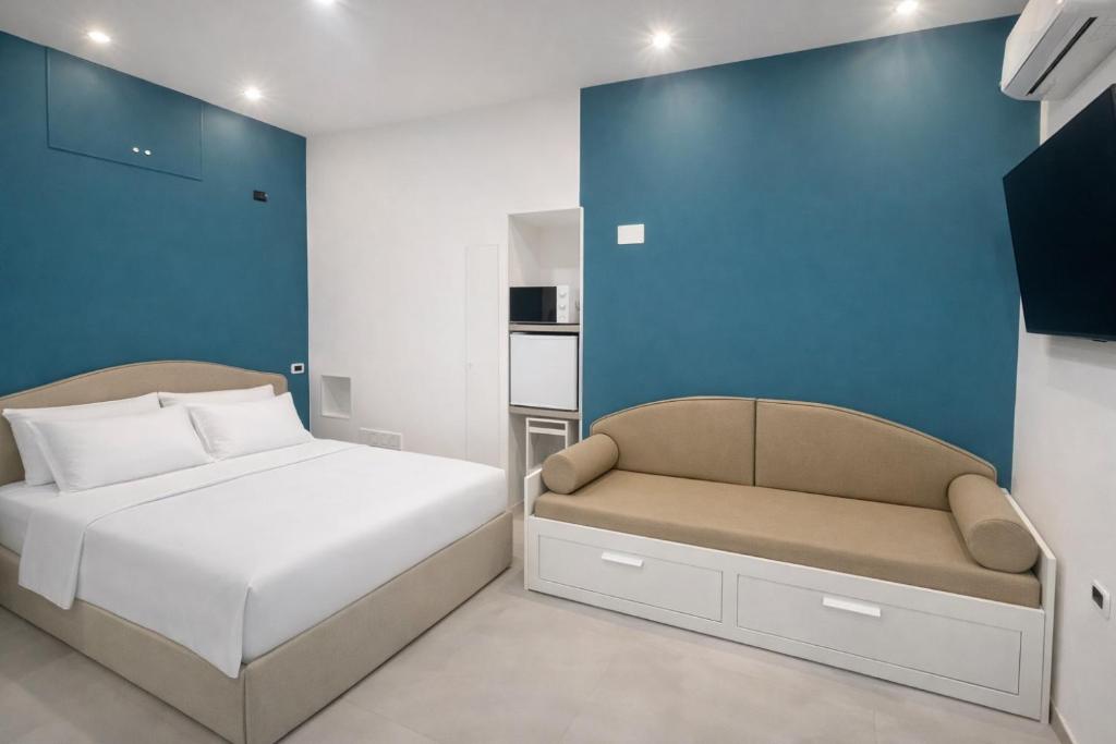 a small bedroom with a bed and a chair at Casa Schiattarella Napoli in Naples