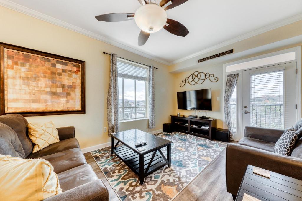 a living room with a couch and a table at River View Condo Sleeps 6 Shared Hot Tub & Pool in Pigeon Forge