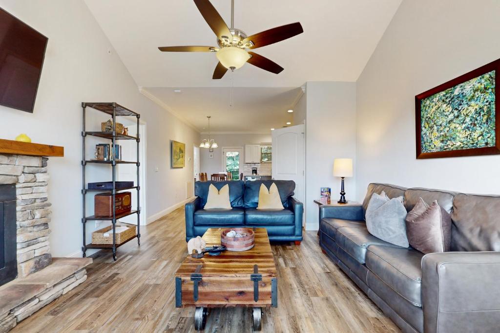 a living room with a couch and a ceiling fan at Pristine & Peaceful Condo Sleeps 6 Shared Pool & Townsend Timbers in Townsend