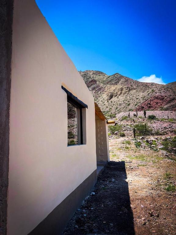 a building with a window on the side of it at Cabañas Puesta del Sol in Purmamarca