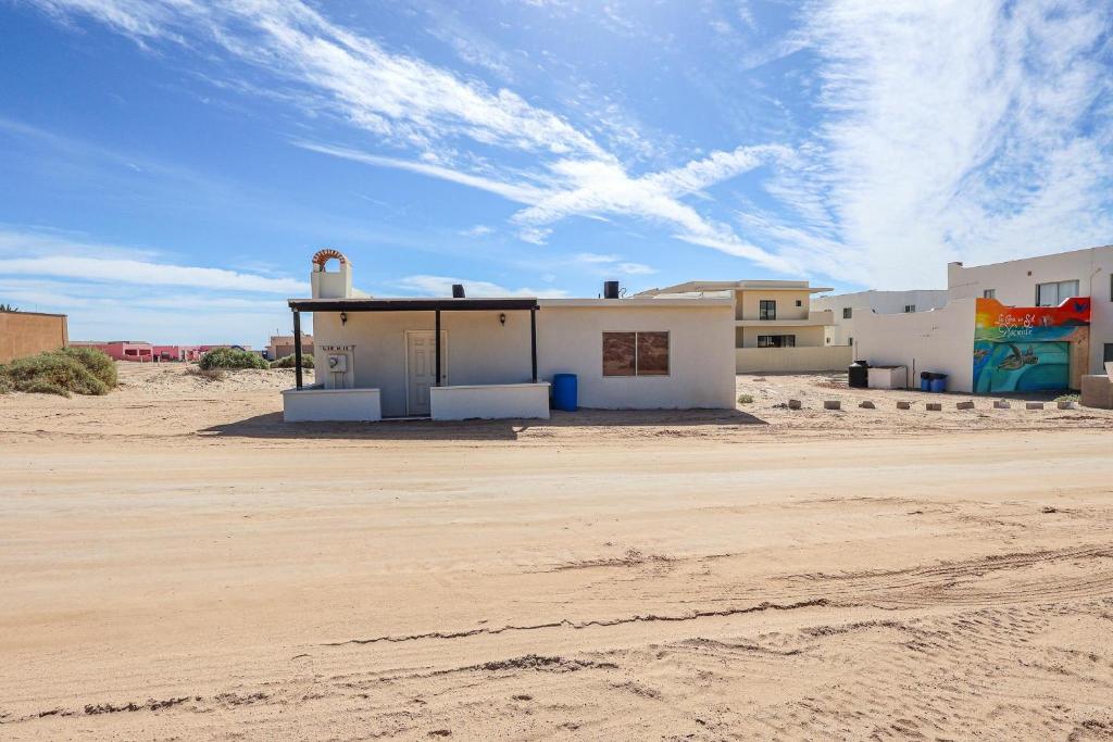 a white building in the middle of a desert at Casa Sonora in Puerto Peñasco