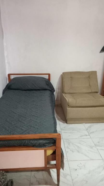 a bedroom with a bed and a couch at El encanto in Santa María