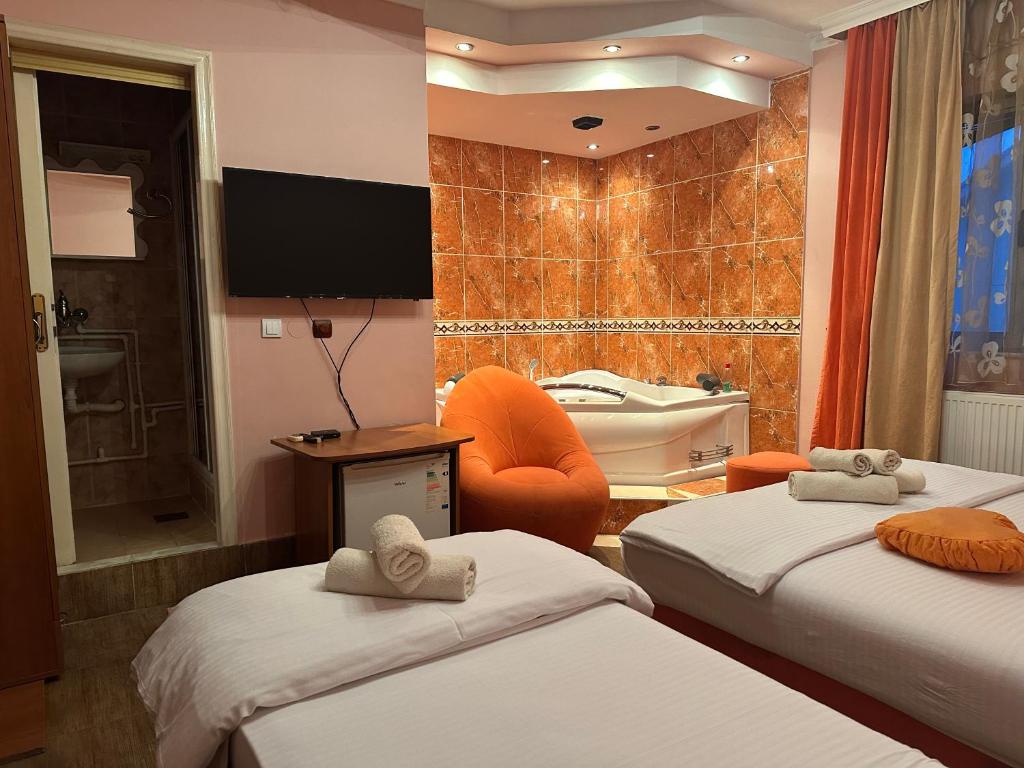 a hotel room with two beds and a bathroom at Restoran Gurman in Kraljevo