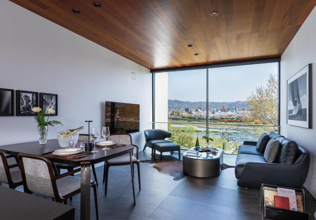 a living room with a table and a couch at Kamo Residences by Reflections in Kyoto