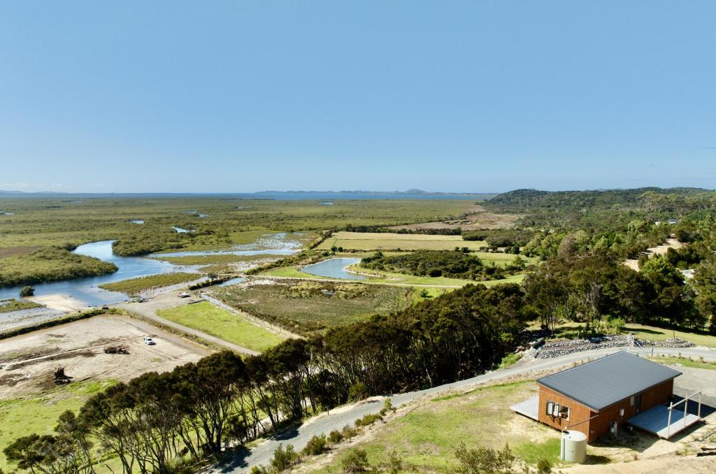an aerial view of a house next to a river at Estuary Escape in Kaingaroa