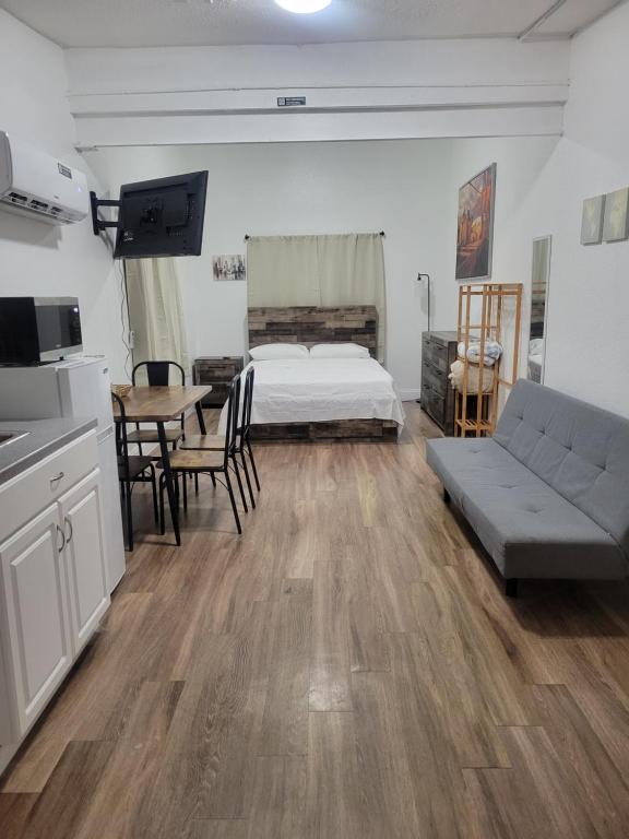 a bedroom with a bed and a table and a couch at Charming Private Studio,Full Amenities, Great Location in Orlando