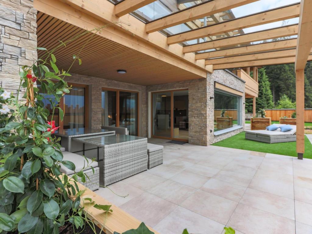 an outdoor patio with a wooden pergola at Kitzbüheler Alpenlodge Top A2 in Mittersill