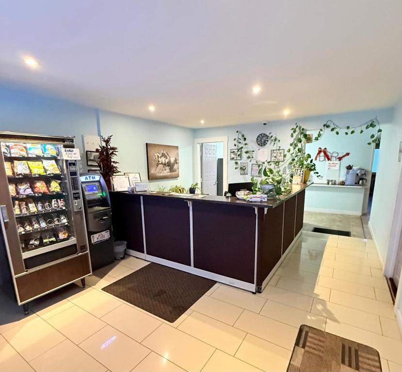 a large kitchen with a counter and a refrigerator at Melville Country Inn in Melville