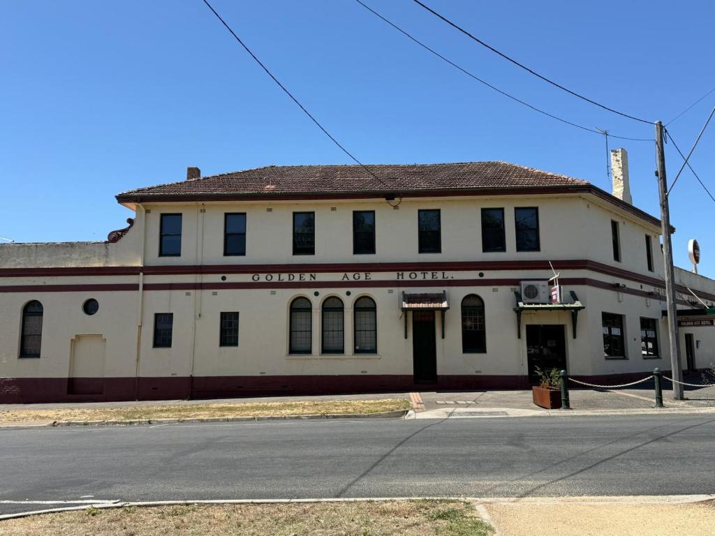 an old white building on the corner of a street at Golden Age Hotel in Beaufort
