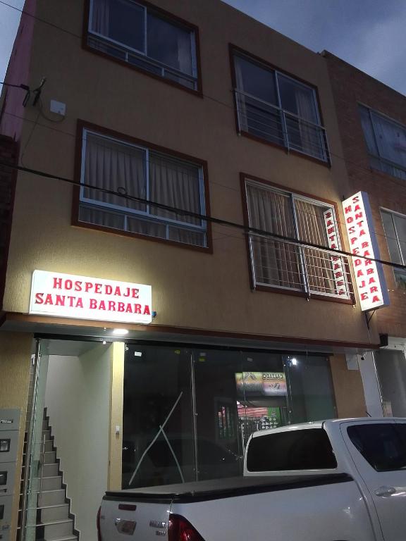 a car parked in front of a santa barbara building at Hospedaje Santa Barbara in Tabio