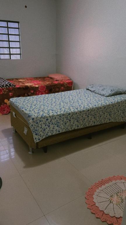 a bedroom with a bed in the corner of a room at Pousada 705 Norte 2 in Brasília