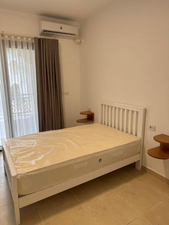 a bedroom with a bed in a room with a window at Celia new capital 3 bedrooms in Cairo