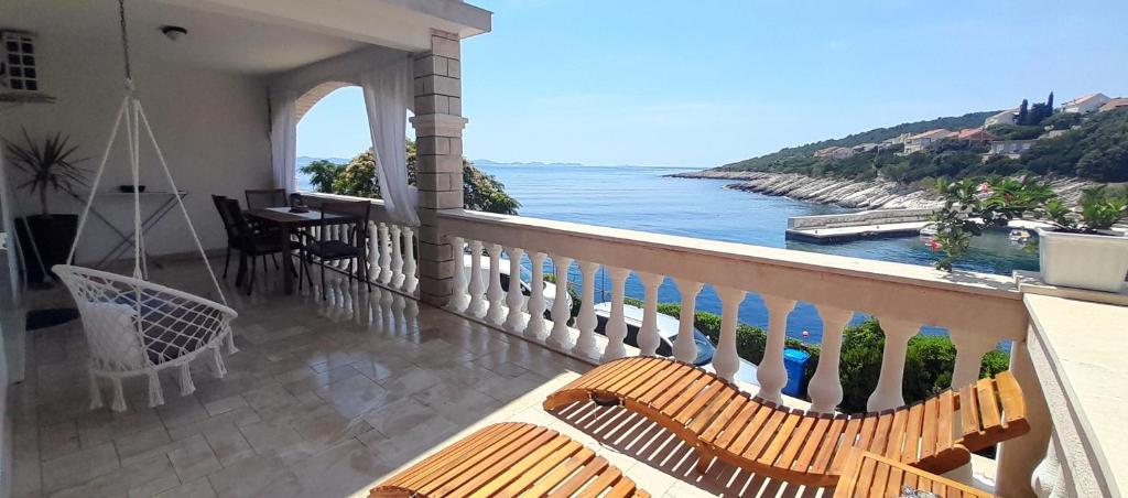 a balcony with chairs and a view of the ocean at Apartment Zavalatica 184a in Čara