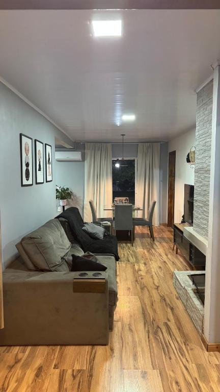 a living room with a bed and a dining room at House in Santa Vitória Do Palmar in Santa Vitória do Palmar