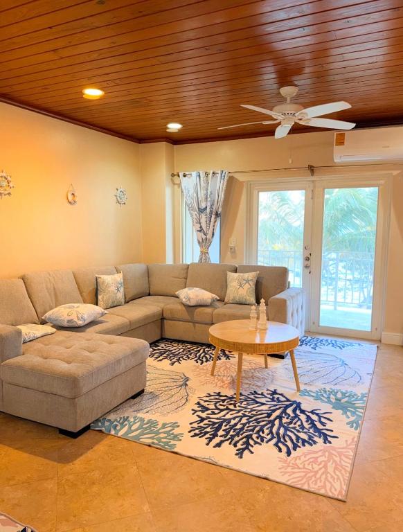 a living room with a couch and a table at 4 story Ocean Villa in Nassau