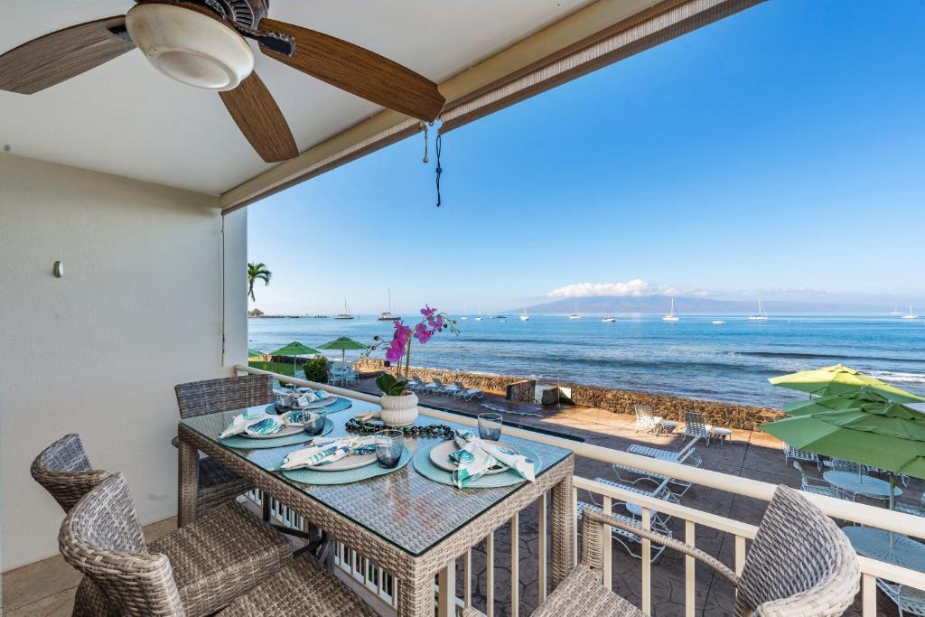 a dining room with a view of the ocean at Lahaina Roads 209 in Lahaina