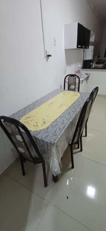 a hospital bed in a room with two chairs at Pousada Lucas in Araruna