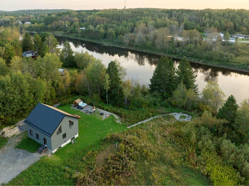 an aerial view of a house next to a river at Batiscan - Waterfront Private Spa & Sauna in Saint Adelphe