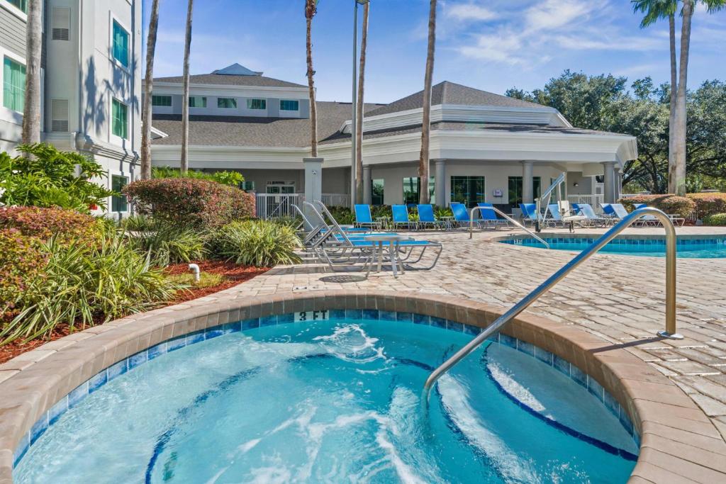 a pool at a resort with blue chairs at Free Shuttle Mickey Universal Epic SeaWorld in Orlando