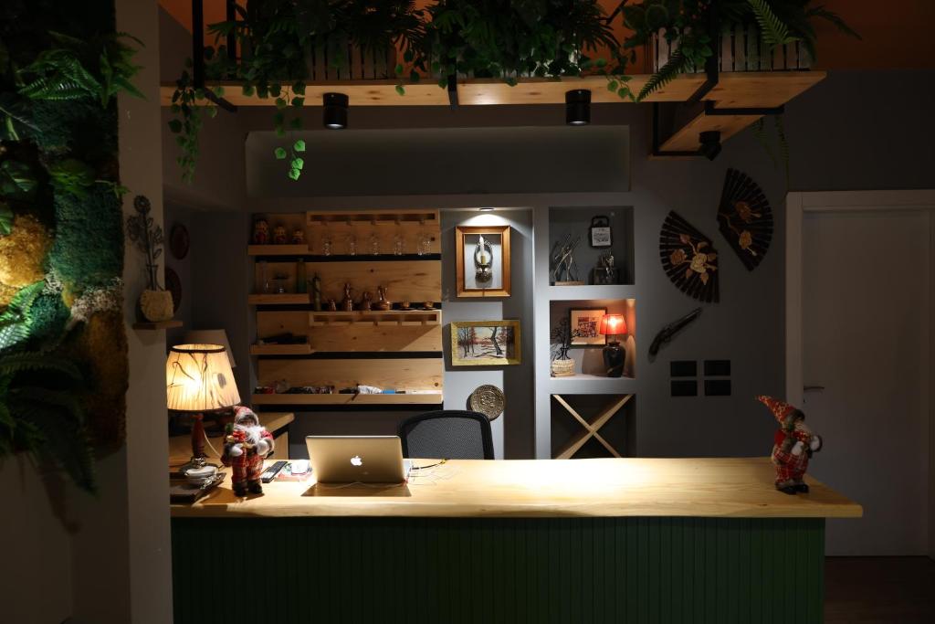 a room with a desk with a laptop on it at SMALL Boutique & Garden in Tirana
