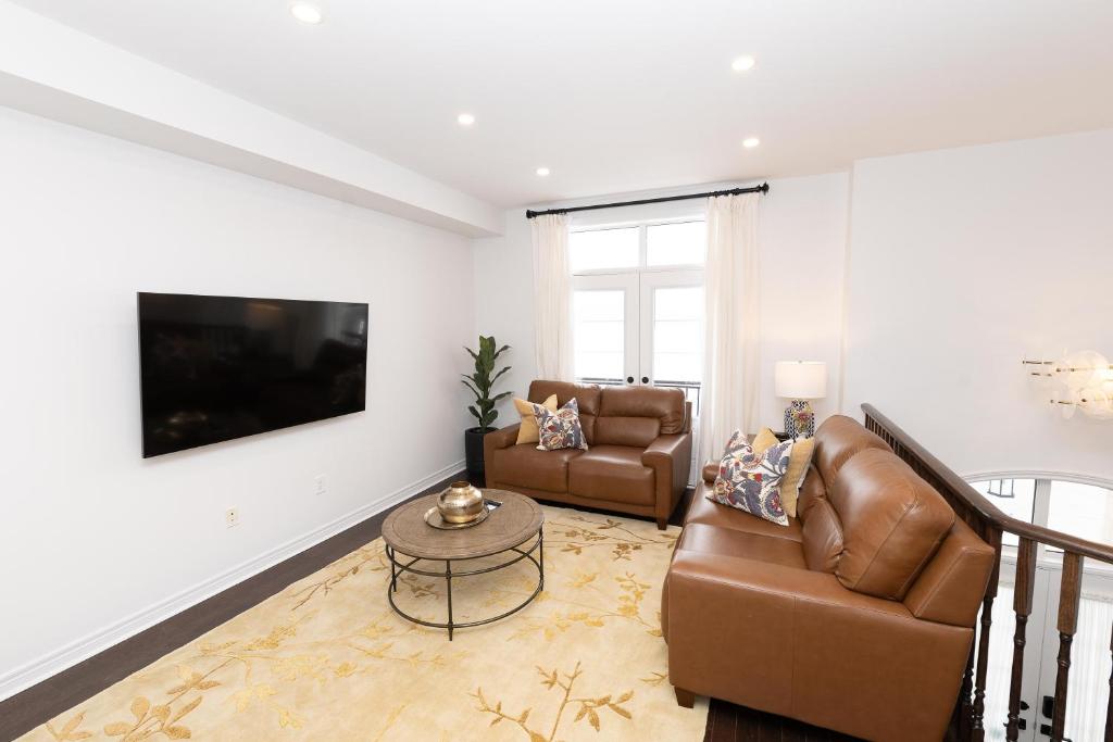 a living room with a couch and a table at Vacation Home in Vaughan in Vaughan