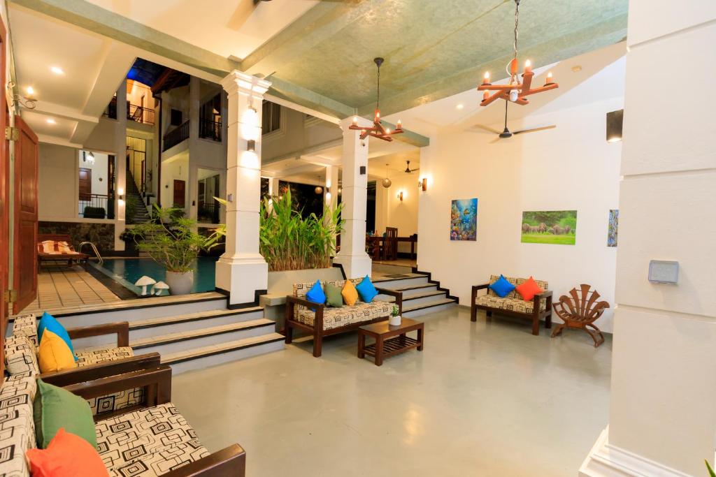 a lobby of a resort with couches and chairs at Hikka Boutique in Hikkaduwa