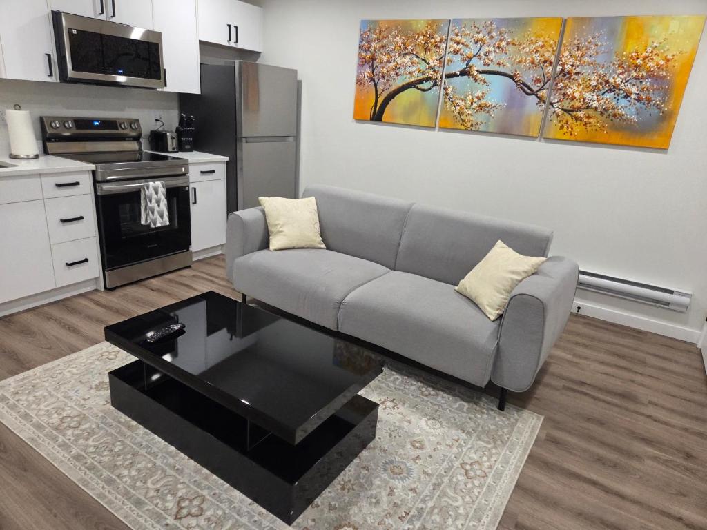 a living room with a couch and a coffee table at The Heavenly Crib in Saskatoon