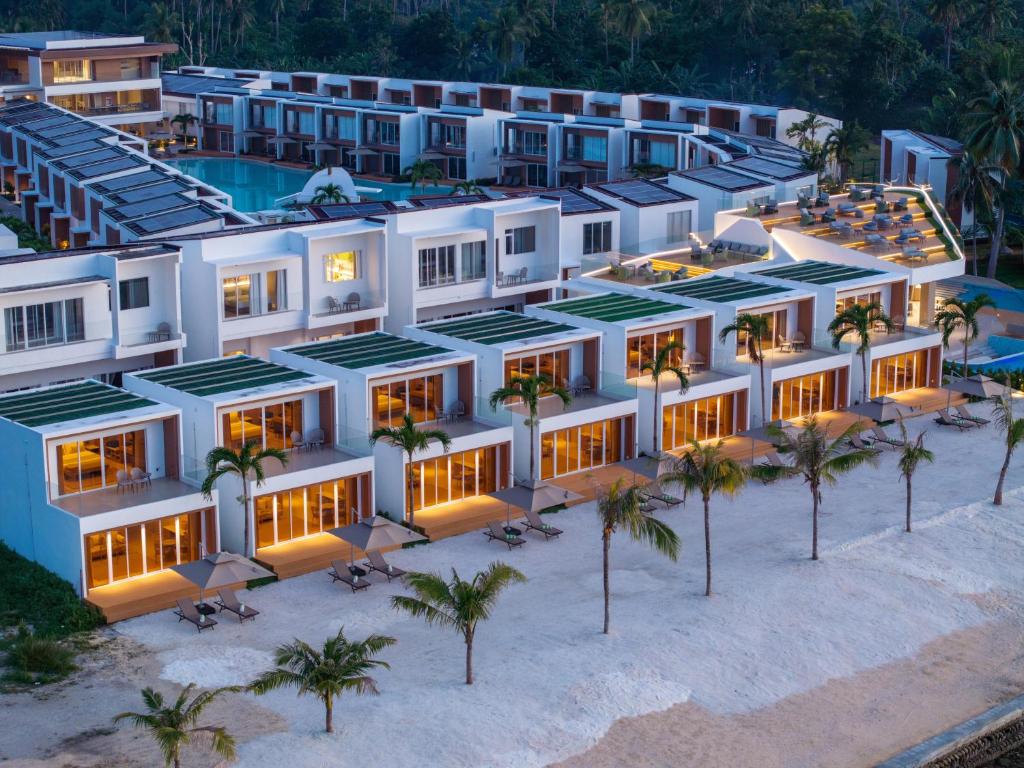 an aerial view of a resort with palm trees at LIME Resort Bohol, a member of Radisson Individuals Premier in Panglao Island