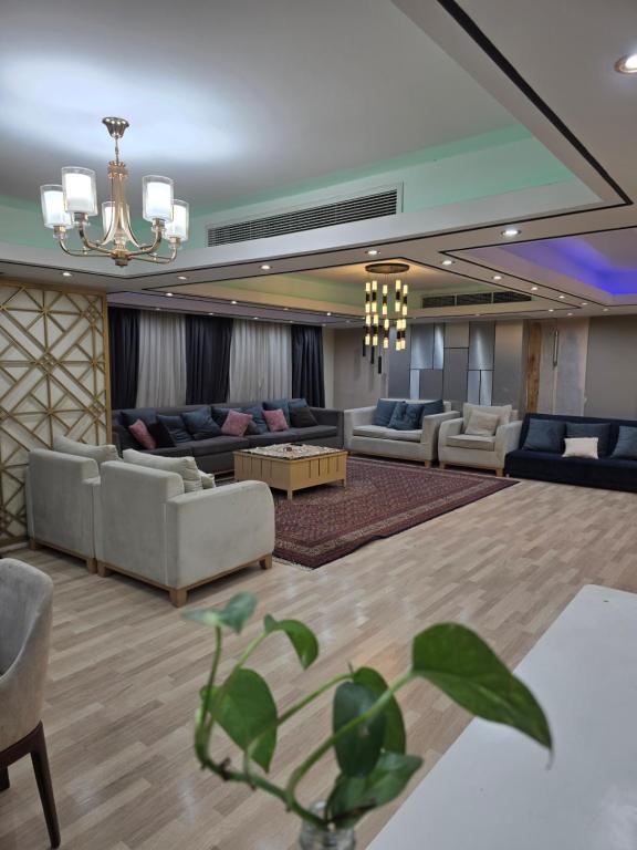 a large living room with couches and a chandelier at luxury hotels home in Cairo